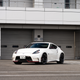 a white 2022 nissan fairlady z parked in front of a closed garage door